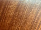 a close up of a wooden table with a clock on it