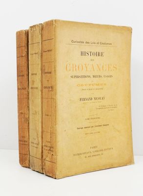 three old books sitting on top of each other on a table