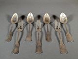 six forks and spoons are arranged in a row on a table