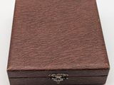 a close up of a wooden box on a white surface