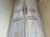 a tall wooden cabinet in the corner of a room