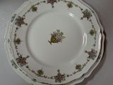 a plate with a bee on it sitting on a table