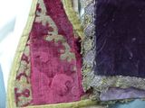 two pieces of purple and red fabric on a table