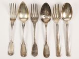 five spoons and a fork on a white surface
