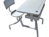 an image of a desk and chair with a laptop on it