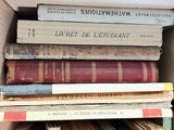 many books stacked on top of each other in a box