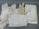 a lot of white laces on a table next to a box