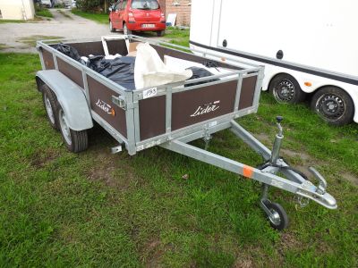 a trailer with a dog in the back of it