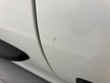 a close up of a white car with a hole in the side
