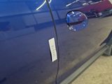 a close up of a car door handle with a sticker on it