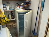 an image of a small kitchen with a refrigerator and a washing machine