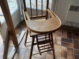 a wooden chair sitting in front of a window in a room