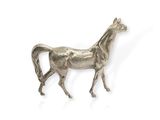 a silver statue of a horse walking on a white surface