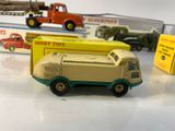 several toy trucks are lined up on a table in front of boxes