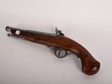 an old gun with a wooden handle on a white surface