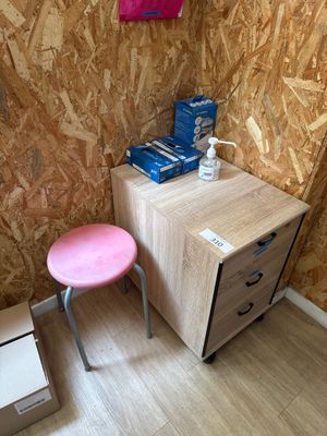 un petit bureau avec un tabouret rose dans un coin de la pièce