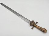 a close up of a knife on a white surface with a ruler