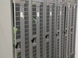 many metal lockers in a room with tile flooring