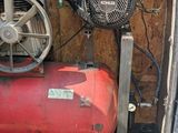 a small air compressor in the back of a van