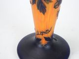 a vase with a design on it on a black base