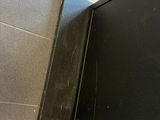 a black television sitting on top of a metal stand