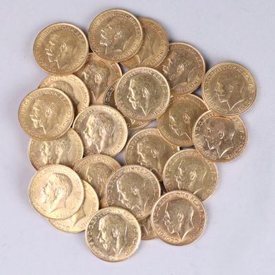 a pile of gold coins sitting on a white surface