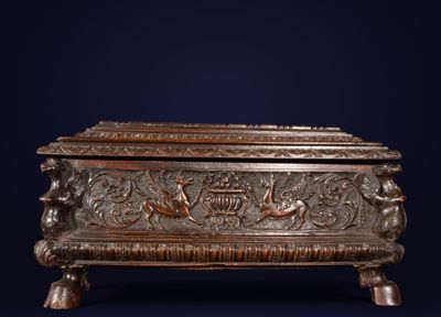 an antique bronze box with a design of birds and flowers on it