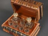 four glasses in a wooden box on a table