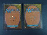 two decks of magic the gathering are shown on a black surface