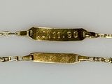 pair of gold plated bracelets with engraved names on them