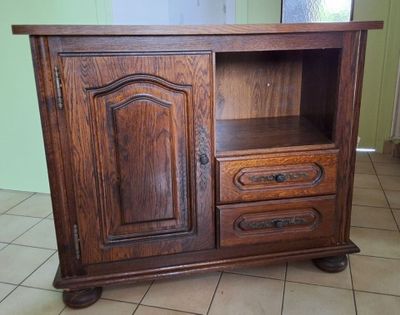 a wooden cabinet with two drawers and a door