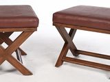 pair of wooden stools with brown leather upholstered seats