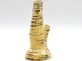 a yellow vase that is sitting on a white surface