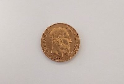 a close up of a gold coin on a white surface