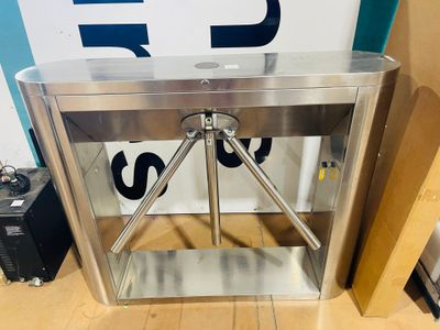 a stainless steel turnstiler in a room with a blue and white sign