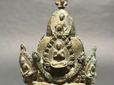 an image of a bronze statue of a buddha sitting on a throne