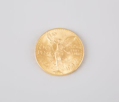 a close up of a gold coin on a white surface