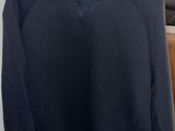 a blue sweater hanging on a hanger in a room