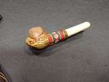 a small wooden pipe with a hat on top of it