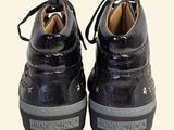 they are two pairs of black shoes with laces on them