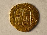 une image représentant une pièce d'or sur laquelle figure l'effigie d'un bâtiment