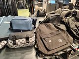 several pieces of luggage sitting on top of a table in a store