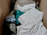 a cardboard box filled with clothes and other items