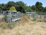 a fence that has a bench in the middle of it