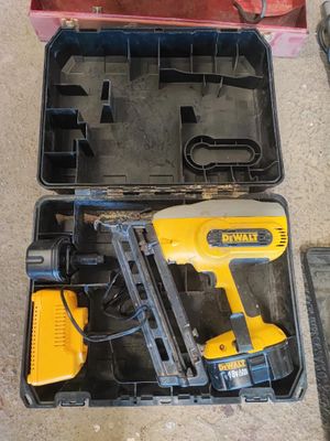 une cloueuse à fil jaune et noire et une boîte à outils