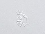 a close up of a white paper with a crown on it