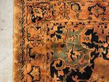 an old rug with a design on it sitting on a floor