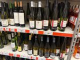 many bottles of wine on the shelves in the store