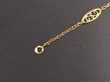 a close up of a gold bracelet on a black surface
