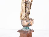 an image of a statue of a woman holding a ball
